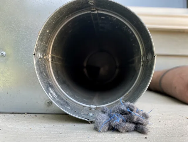 Maywood Dryer Vent Cleaning technician using specialized equipment to clear severe dryer vent blockage in Maywood